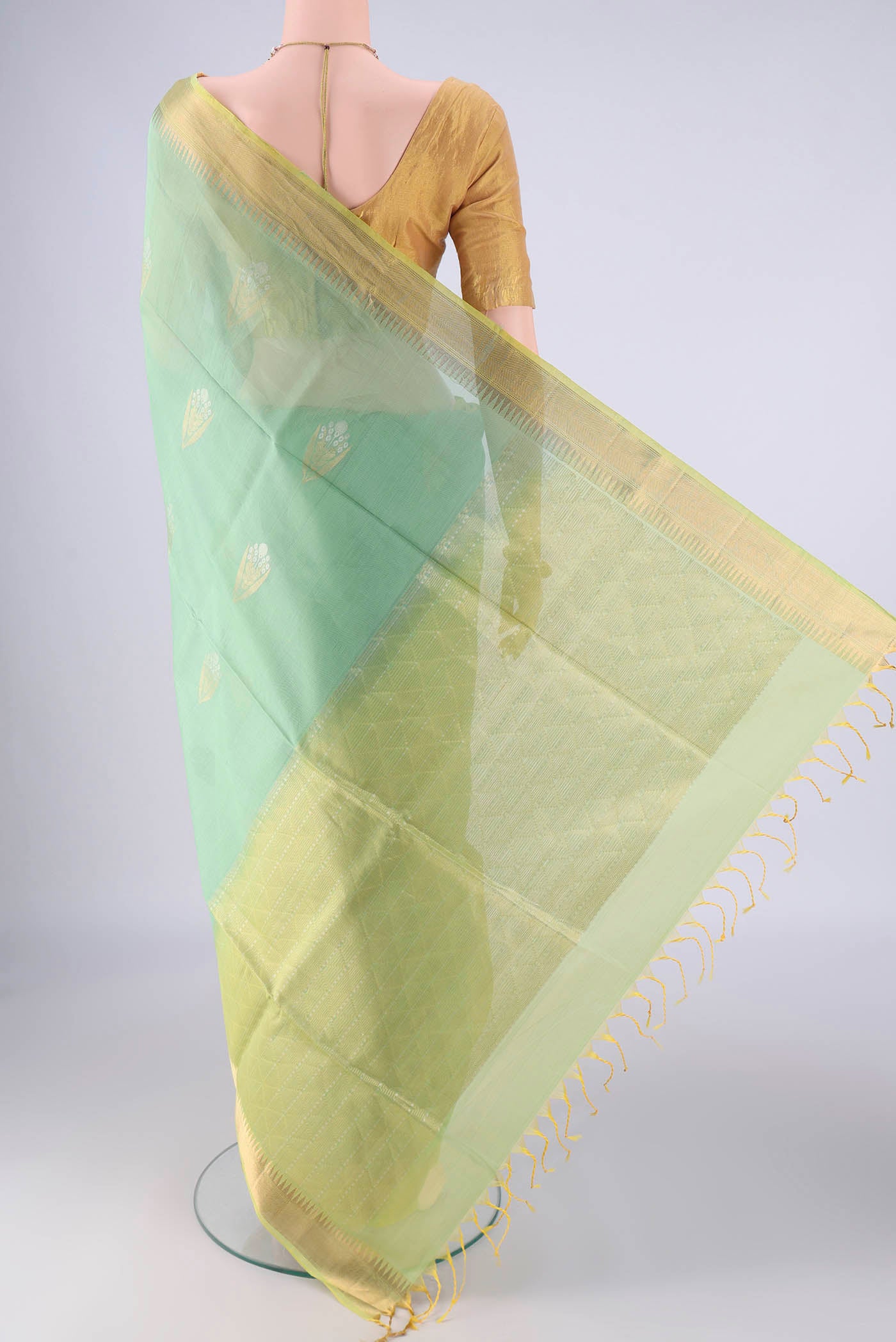 Flat view of Mint Green Silk Cotton Saree with Zari Butta on the body and Zari Border. 
