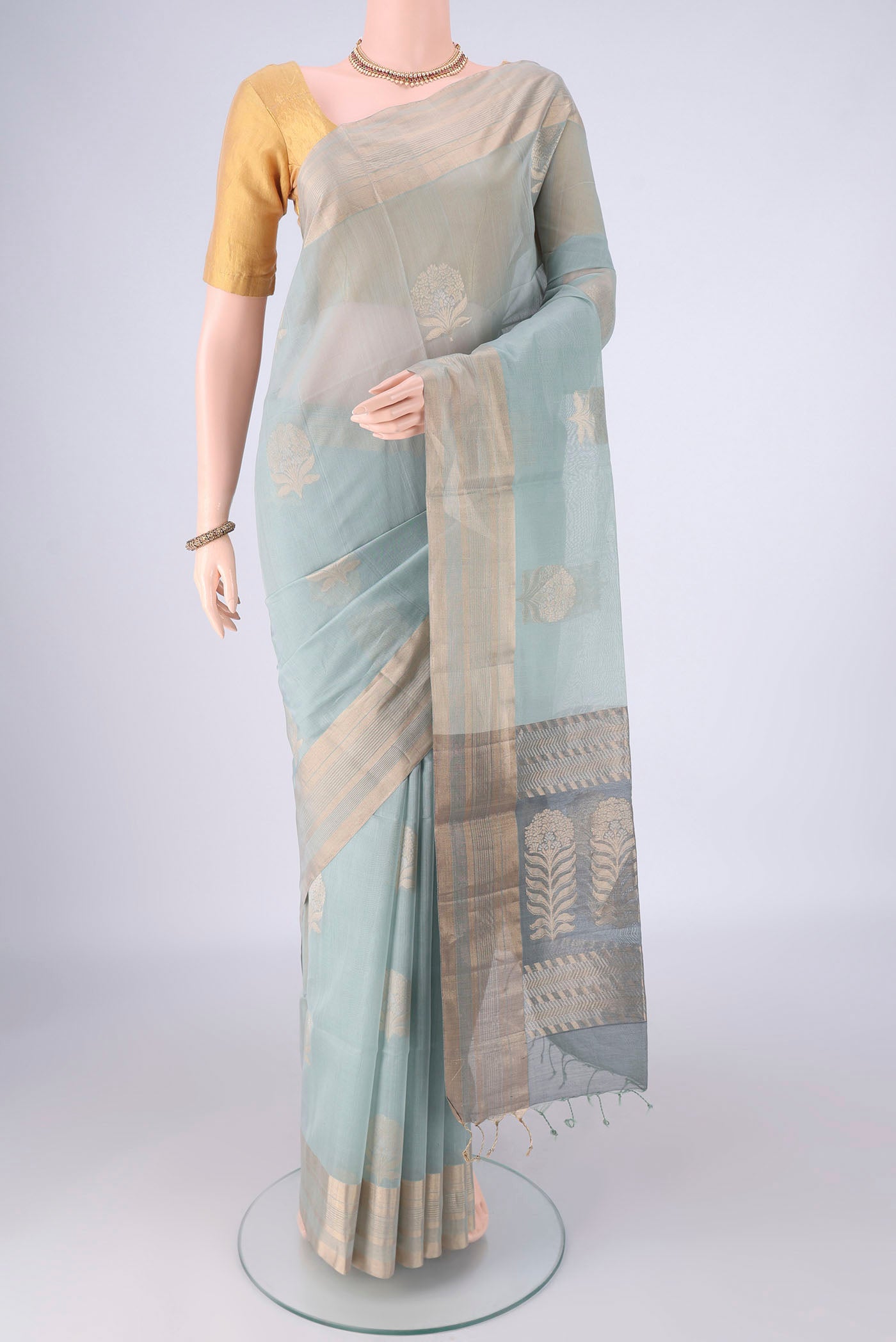 Grey Silk Cotton Saree with Zari Butta on the body and Zari Border.  displayed on a mannequin