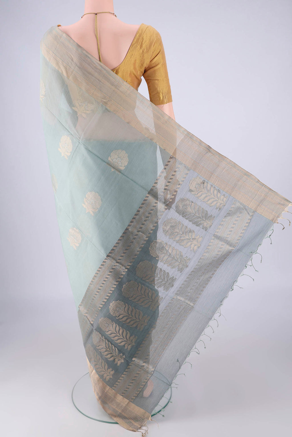 Flat view of Grey Silk Cotton Saree with Zari Butta on the body and Zari Border. 