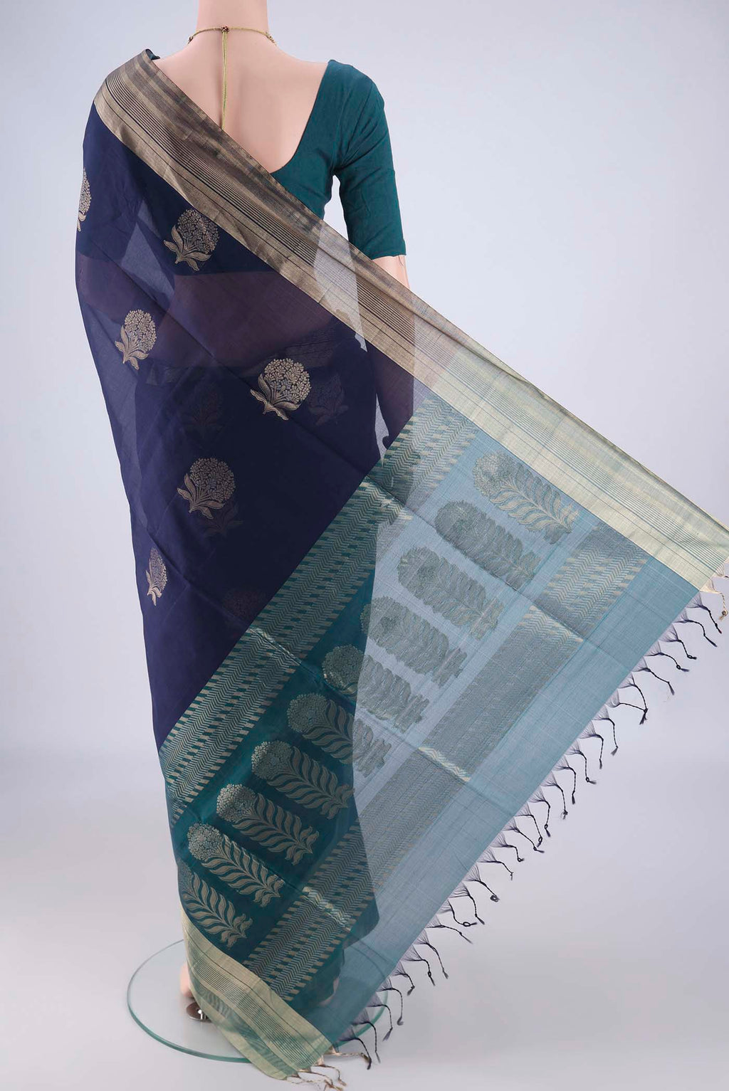 Flat view of Navy Blue Kora Cotton Saree with Zari Butta on the body and Zari Border. 