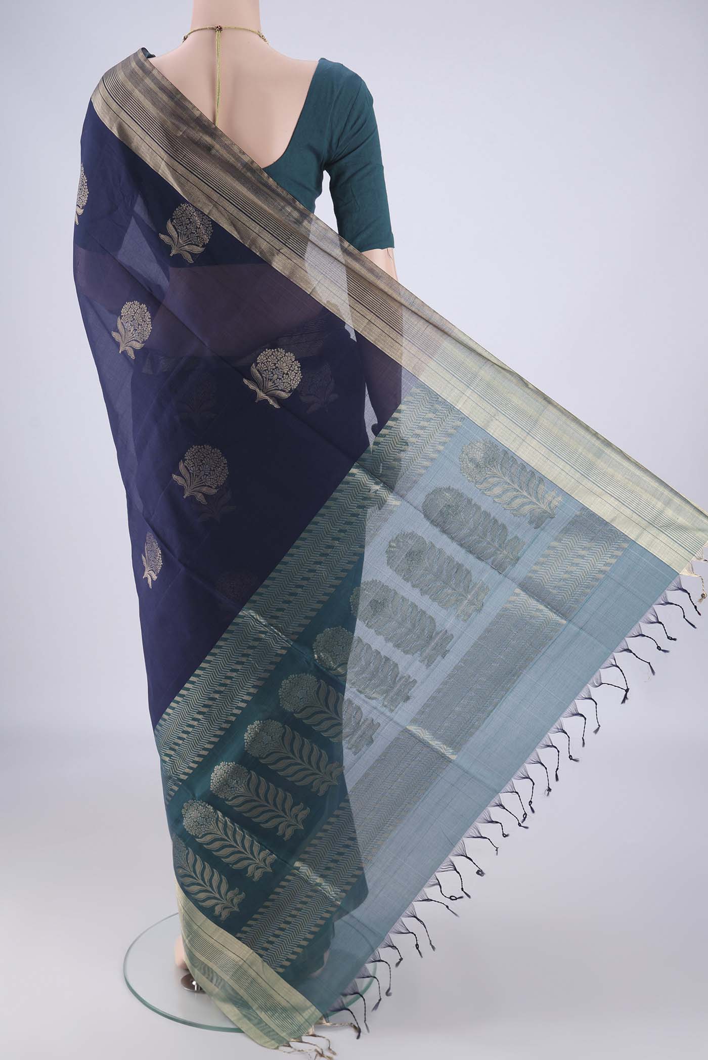 Flat view of Navy Blue Kora Cotton Saree with Zari Butta on the body and Zari Border. 
