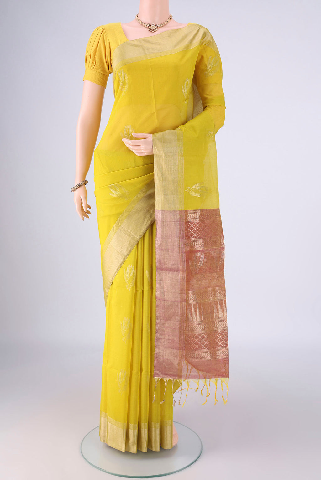 Acid Green Kora Cotton Saree with Zari Butta on the body and Zari Border.  displayed on a mannequin