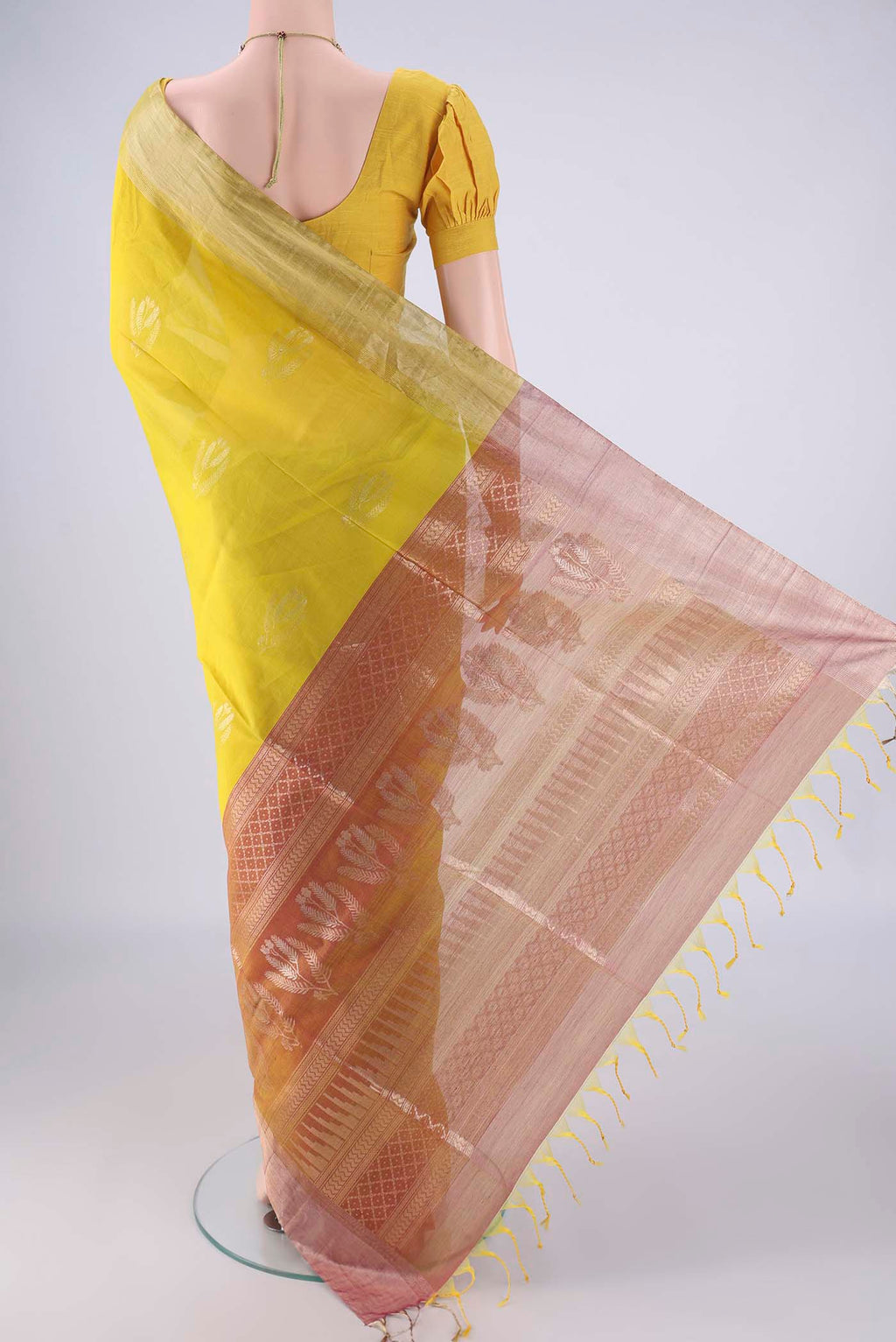 Flat view of Acid Green Kora Cotton Saree with Zari Butta on the body and Zari Border. 