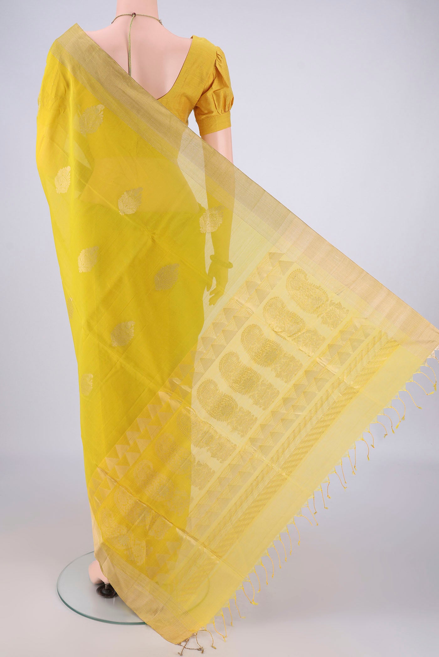 Flat view of Yellow Silk Cotton Saree with Zari Butta on the body and Zari Border. 