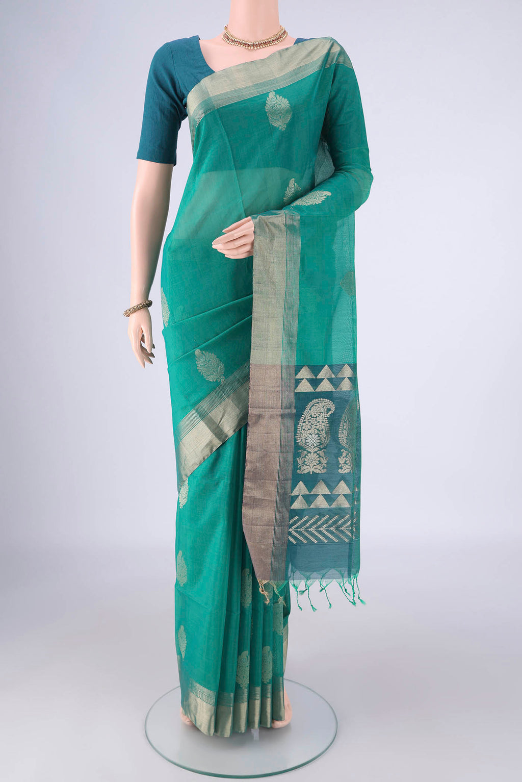 Sea Green Silk Cotton Saree with Zari Butta on the body and Zari Border.  displayed on a mannequin