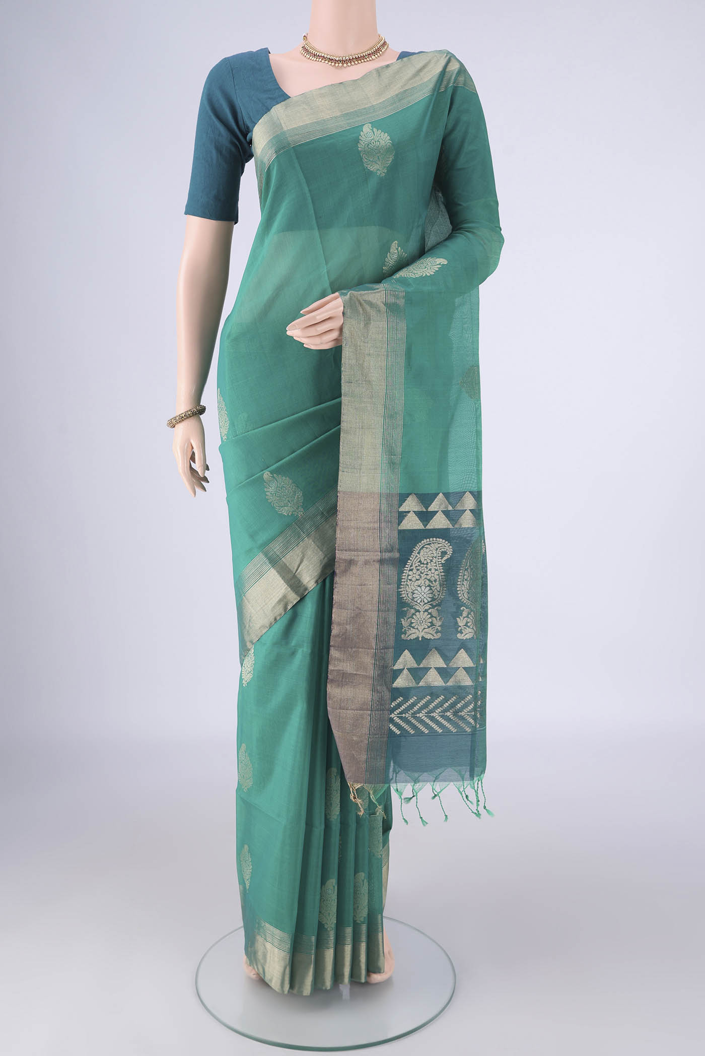 Sea Green Silk Cotton Saree with Zari Butta on the body and Zari Border.  displayed on a mannequin