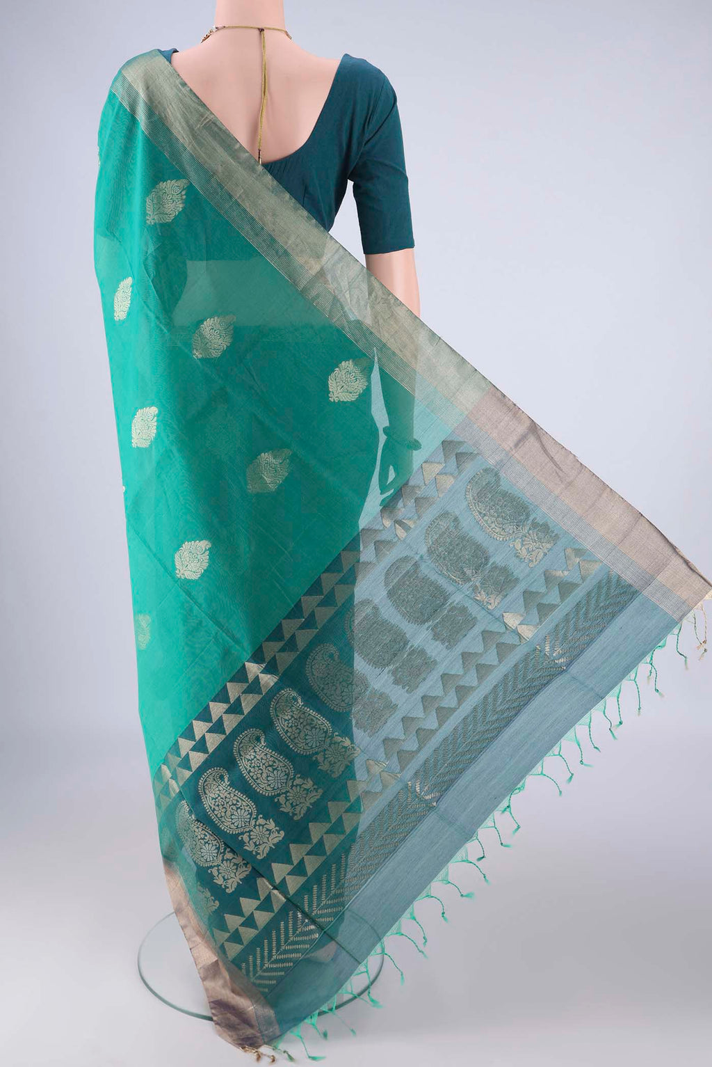Flat view of Sea Green Silk Cotton Saree with Zari Butta on the body and Zari Border. 