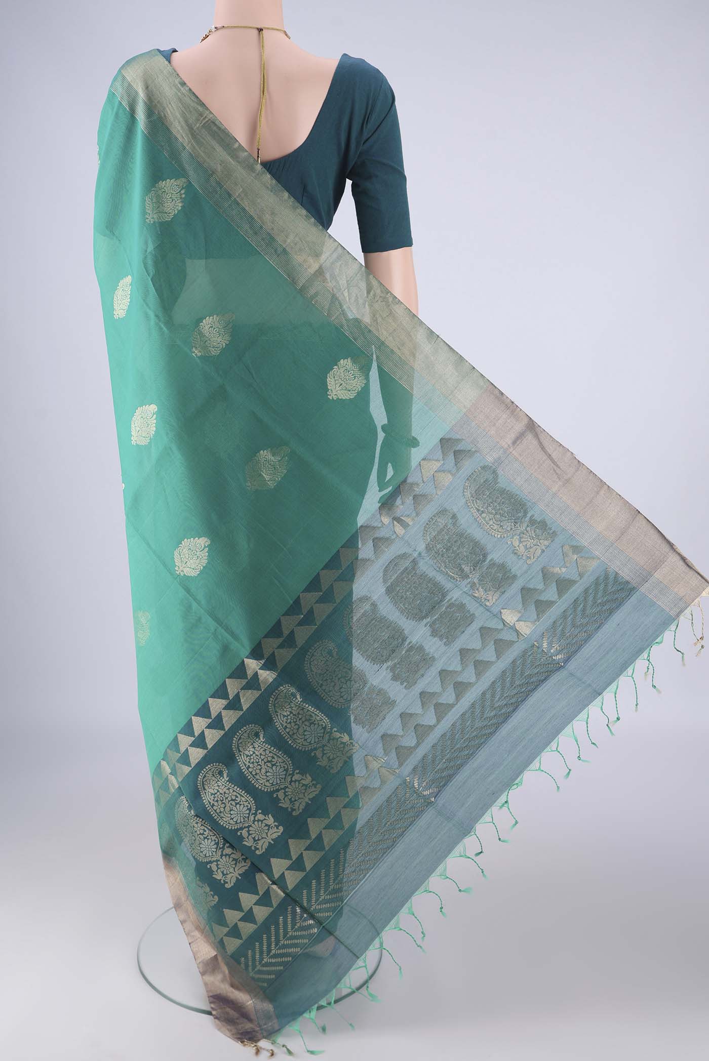 Flat view of Sea Green Silk Cotton Saree with Zari Butta on the body and Zari Border. 