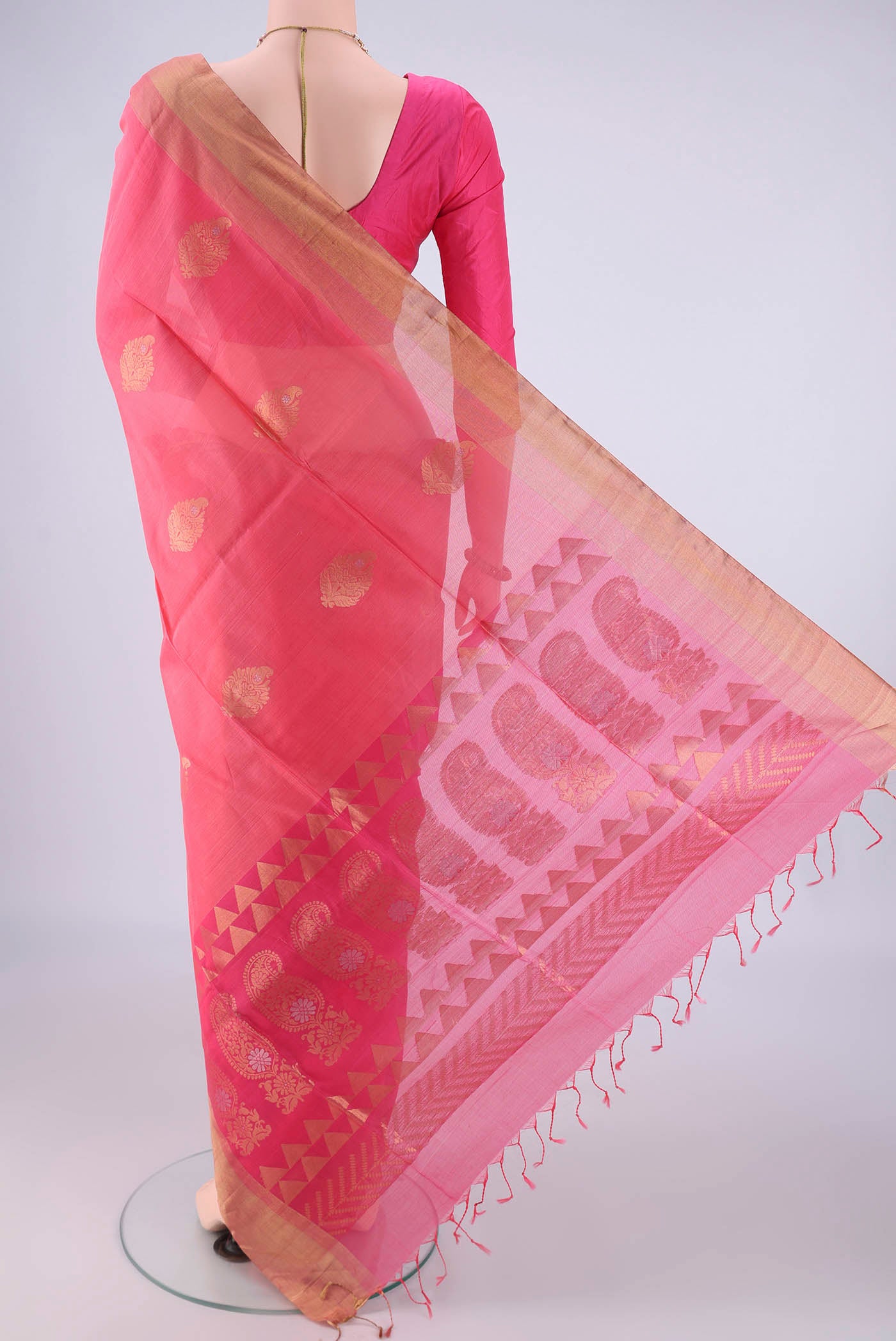 Flat view of Peach Kora Cotton Saree with Zari Butta on the body and Zari Border. 