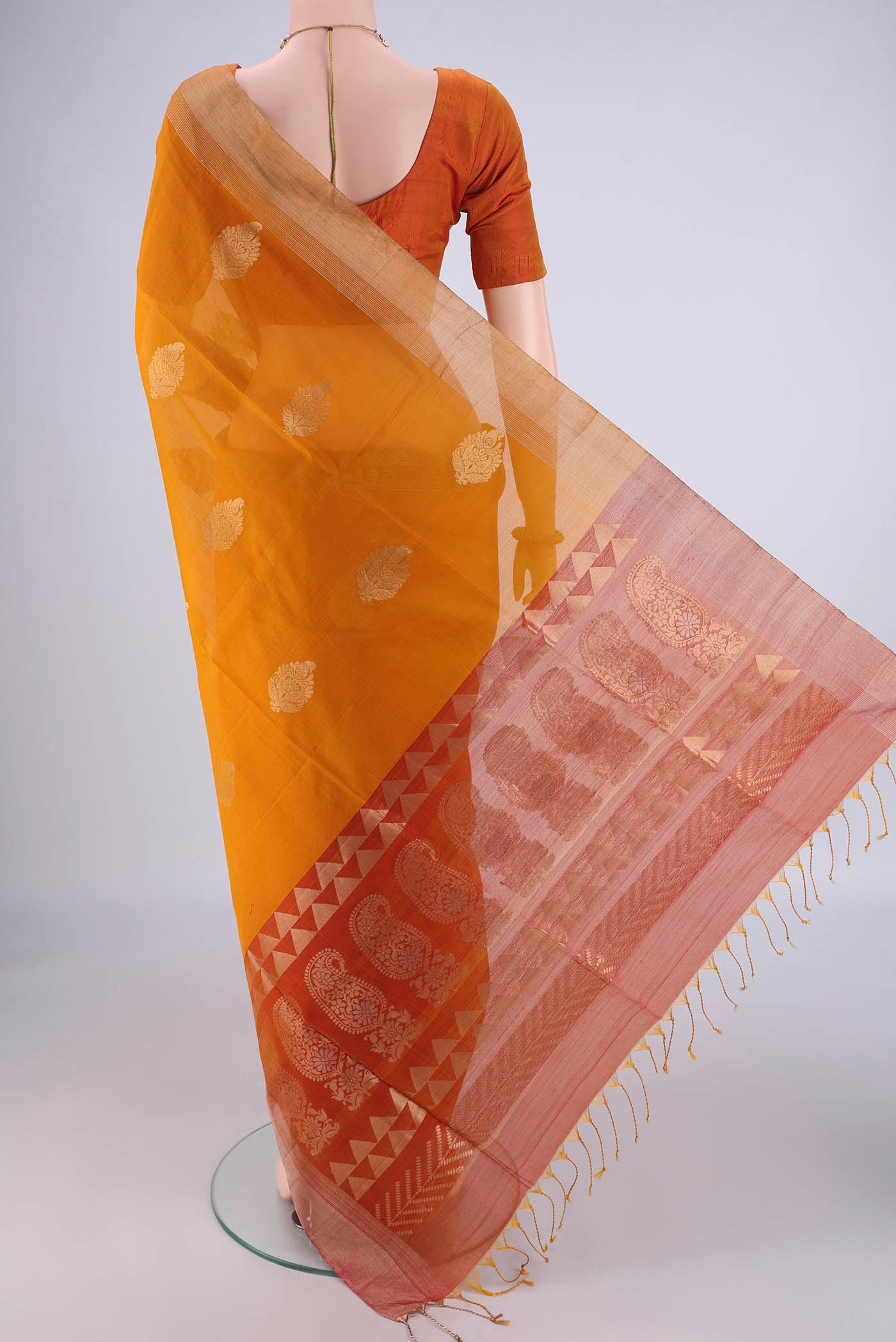 Flat view of Mustard Silk Cotton Saree with Zari Butta on the body and Zari Border. 