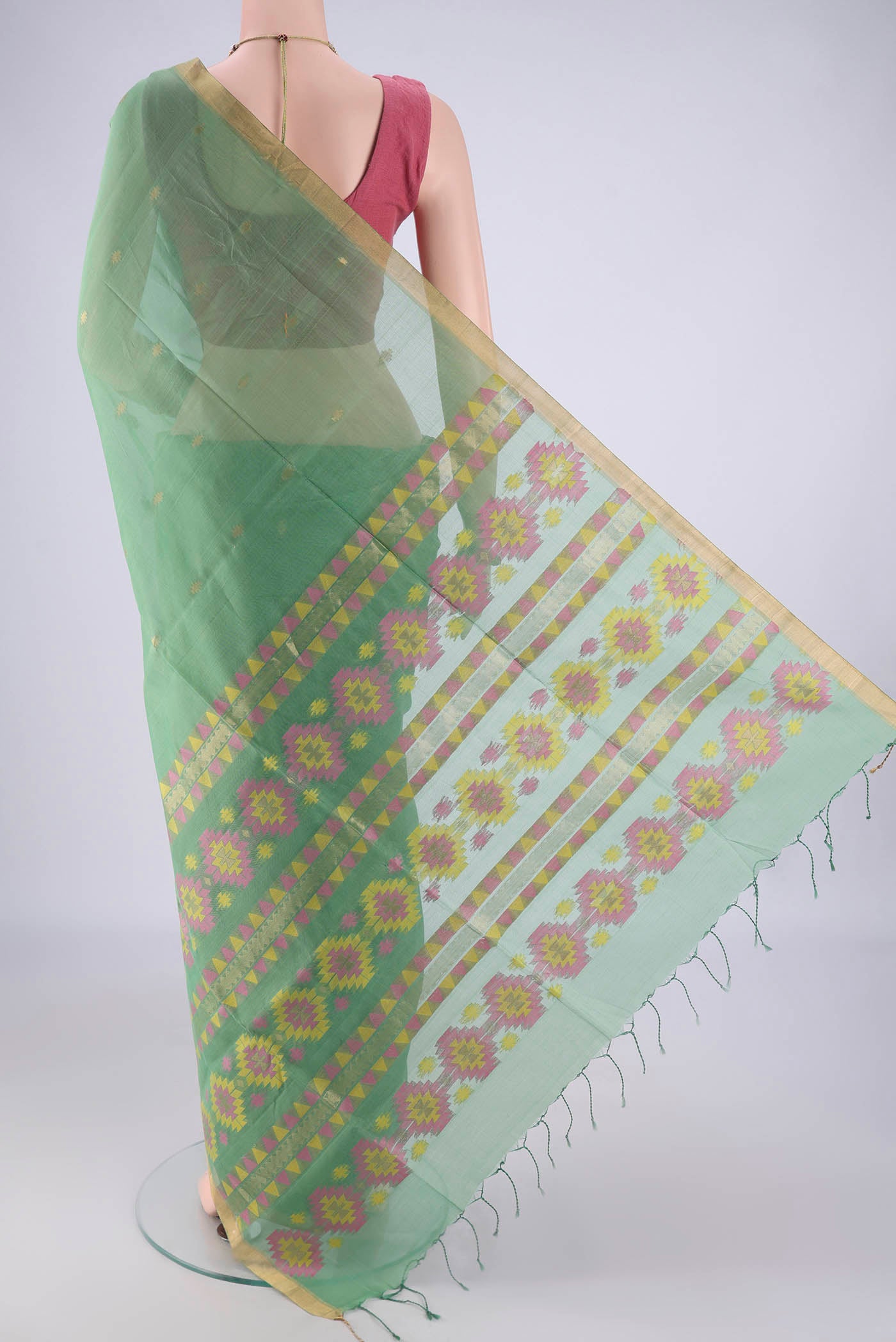 Flat view of Light Green Kora Cotton Saree with Zari Butta on the body and Zari Border. 