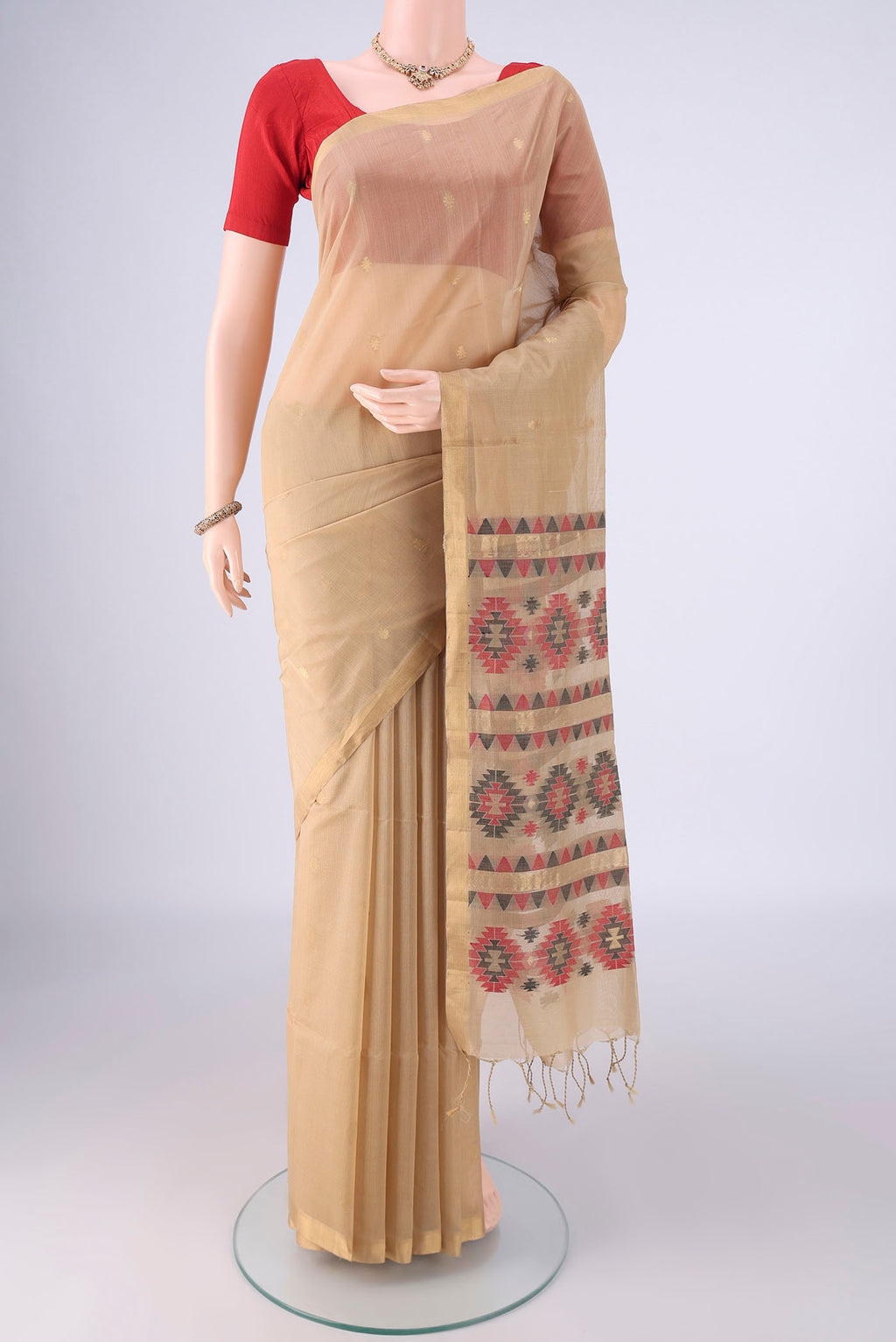 Beige Silk Cotton Saree with Zari Butta on the body and Zari Border.  displayed on a mannequin
