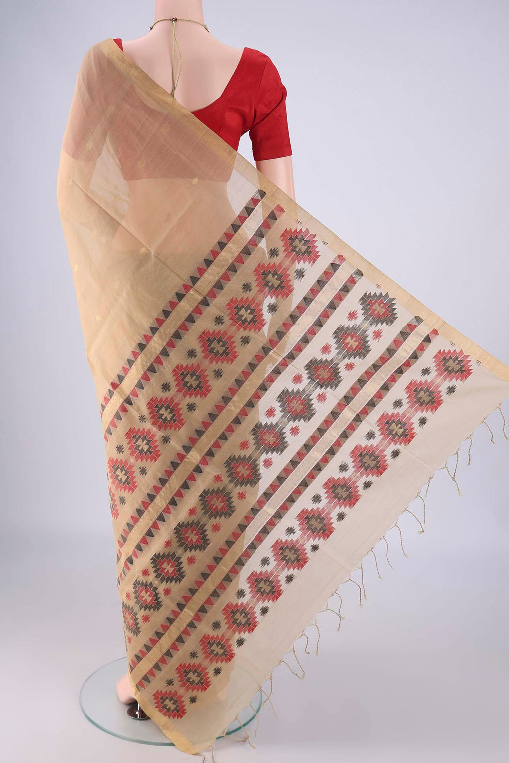 Flat view of Beige Silk Cotton Saree with Zari Butta on the body and Zari Border. 