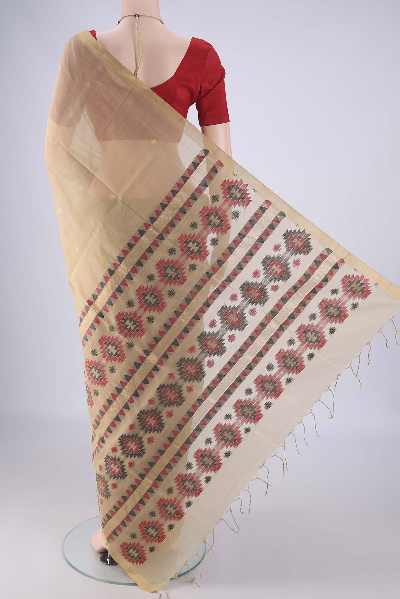 Flat view of Beige Silk Cotton Saree with Zari Butta on the body and Zari Border. 