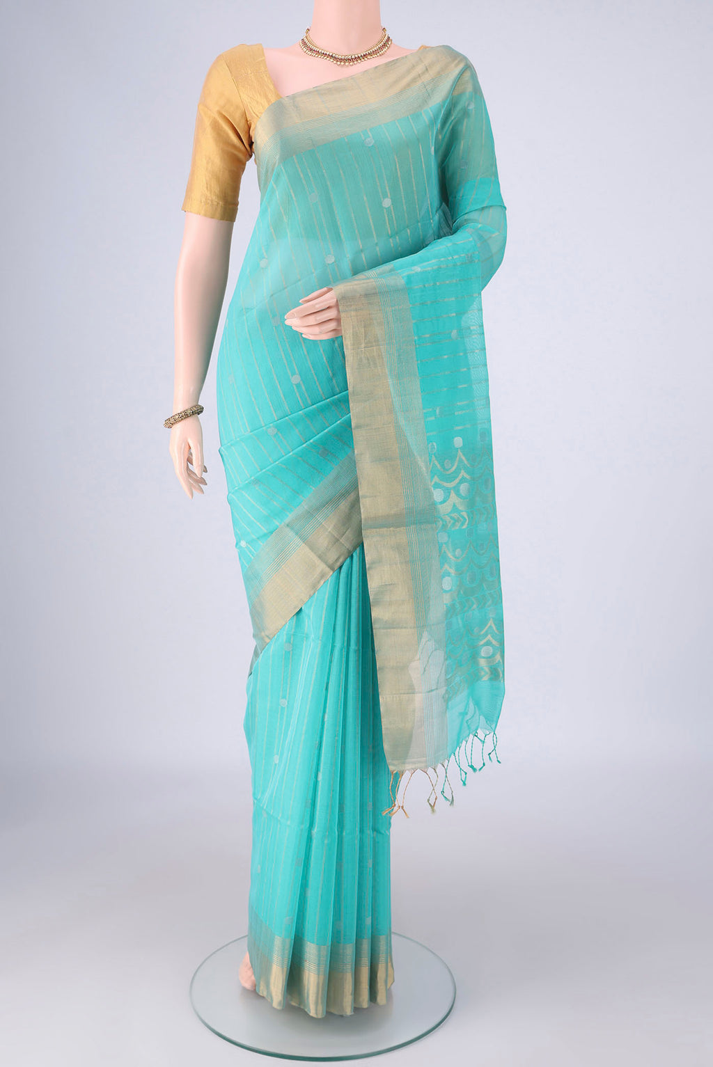 Turquoise Silk Cotton Saree with Stripes on the body and Zari Border.  displayed on a mannequin
