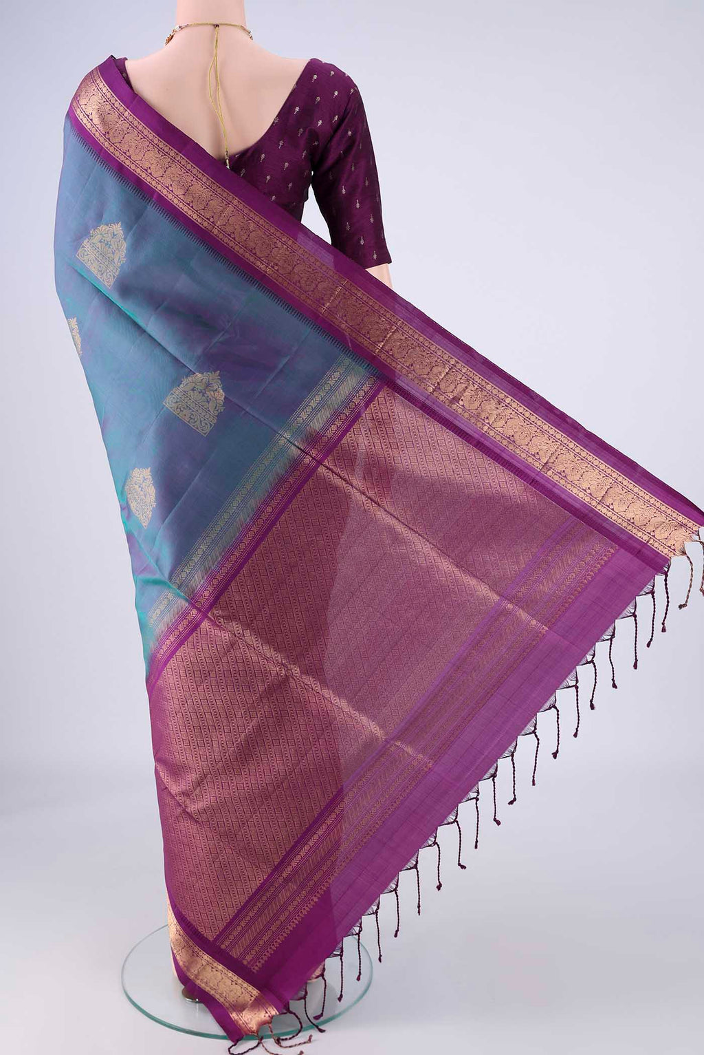 Flat view of Blue Dual Tone Soft Silk Saree with Zari Butta on the body and Zari Border. 