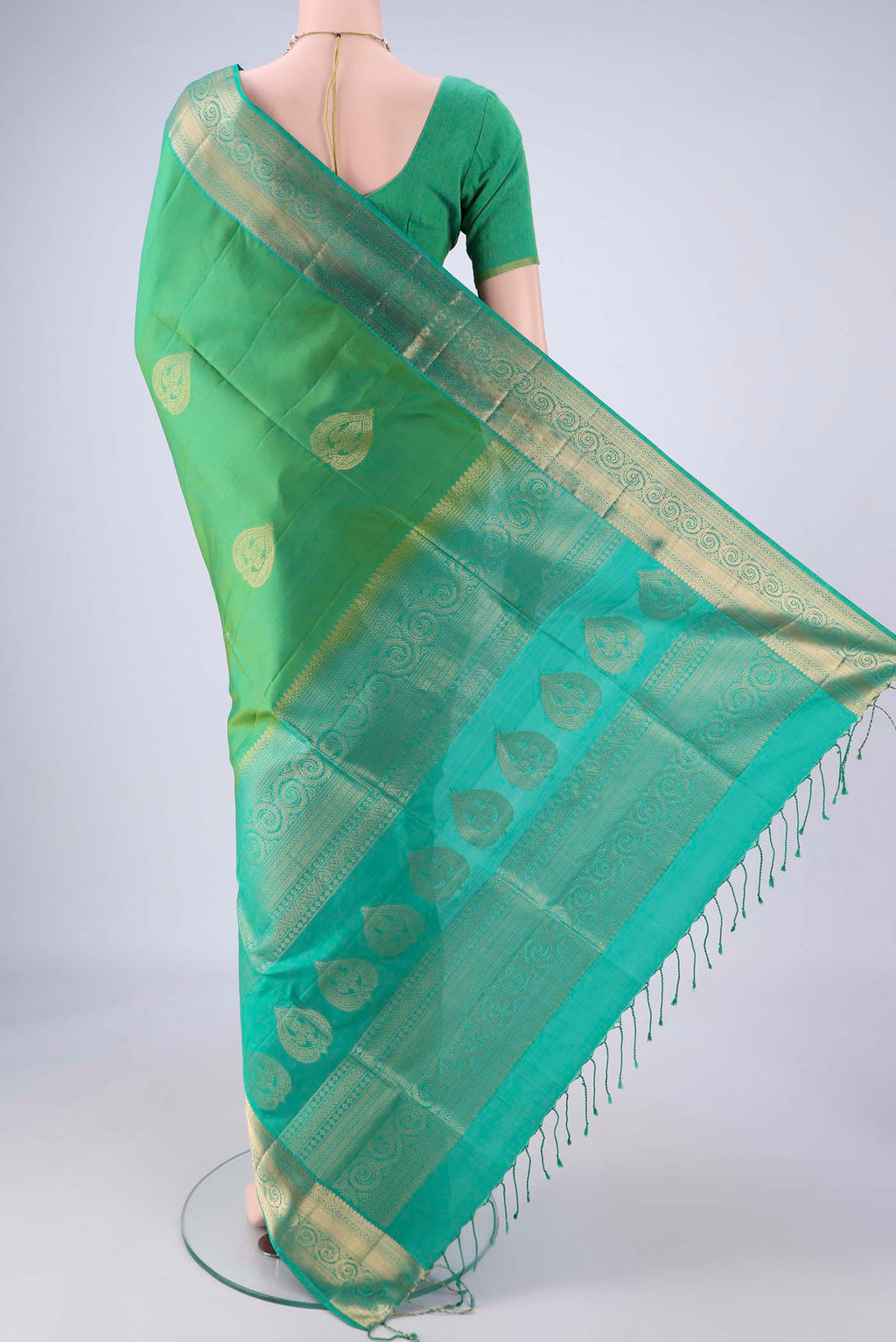 Flat view of Light Green Soft Silk Saree with Zari Butta on the body and Zari Border. 