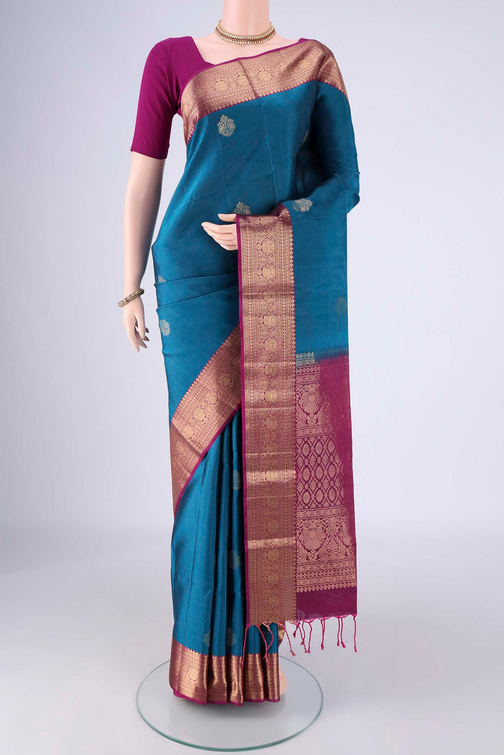 Blue Soft Silk Saree with Zari Butta on the body and Without Border.  displayed on a mannequin