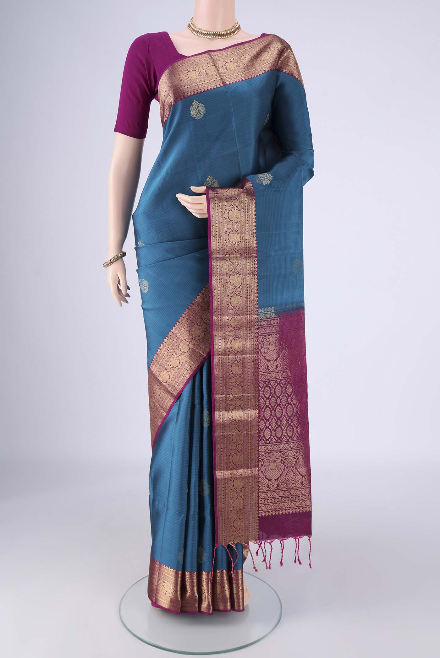 Blue Soft Silk Saree with Zari Butta on the body and Without Border.  displayed on a mannequin