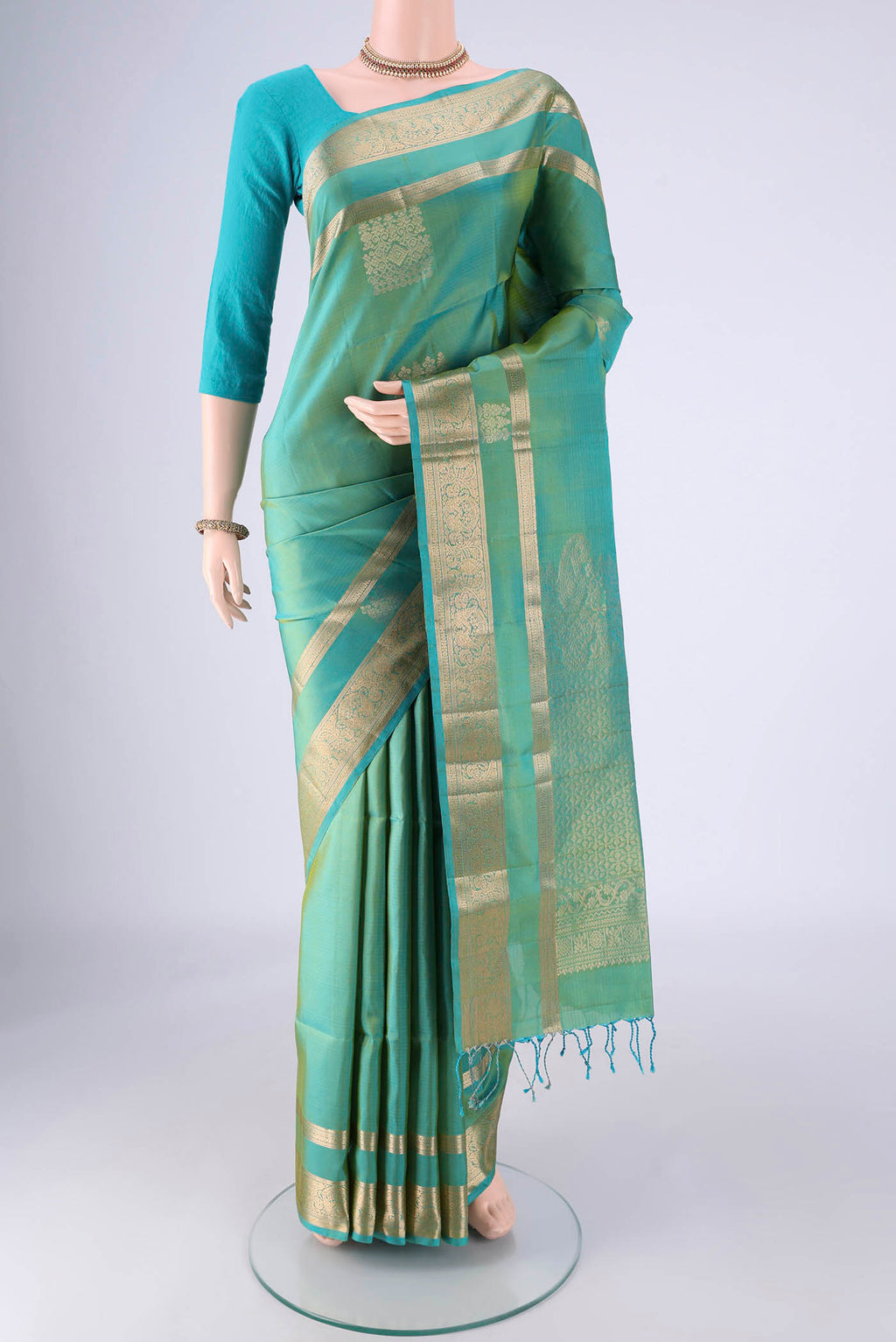 Sea Green Dual Tone Soft Silk Saree with Zari Butta on the body and Zari Border.  displayed on a mannequin