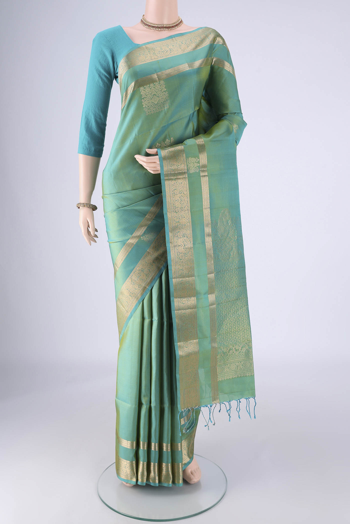 Sea Green Dual Tone Soft Silk Saree with Zari Butta on the body and Zari Border.  displayed on a mannequin