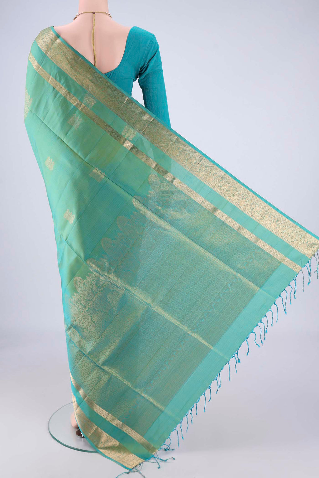Flat view of Sea Green Dual Tone Soft Silk Saree with Zari Butta on the body and Zari Border. 