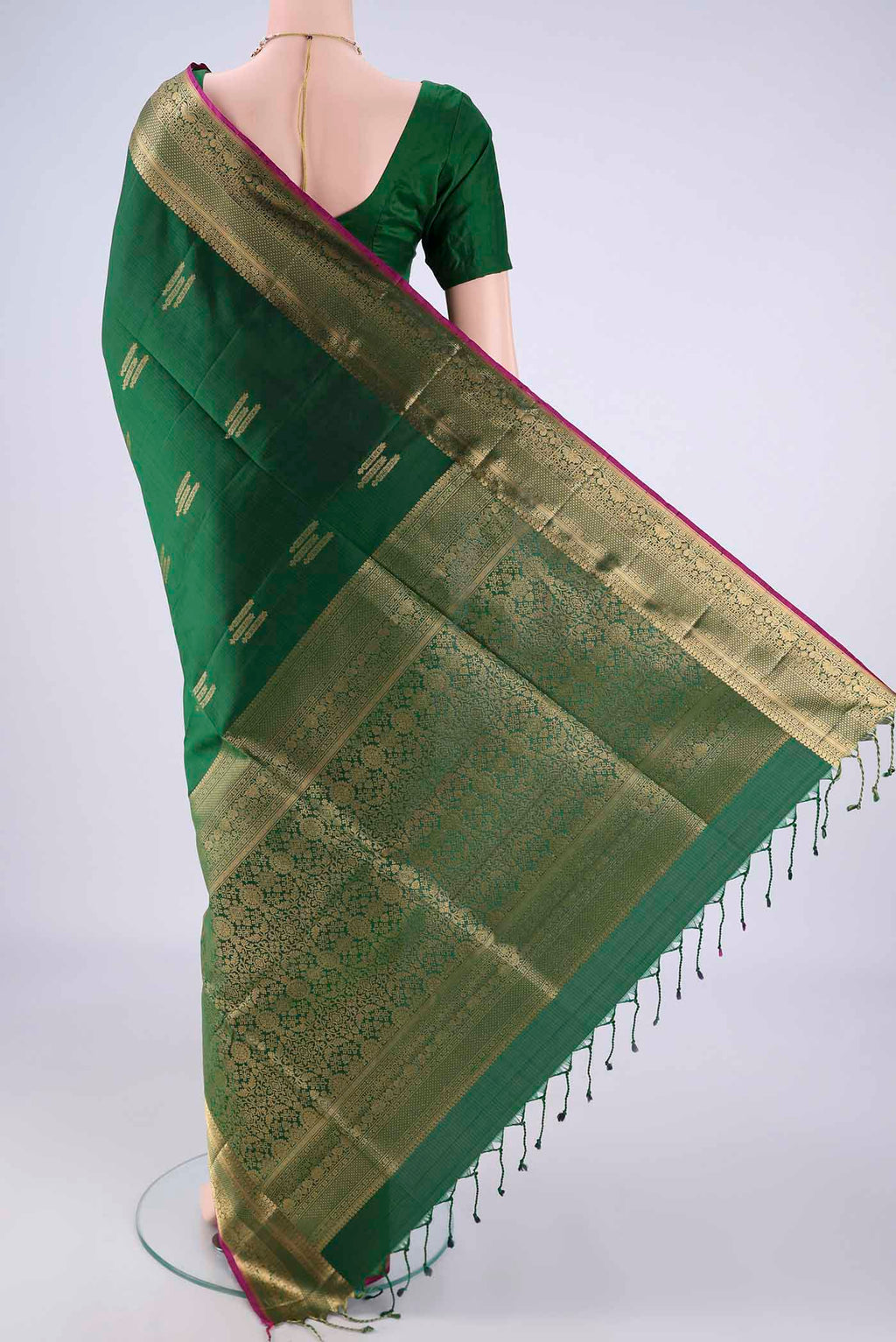 Flat view of Bottle Green Soft Silk Saree with Zari Butta on the body and Zari Border. 