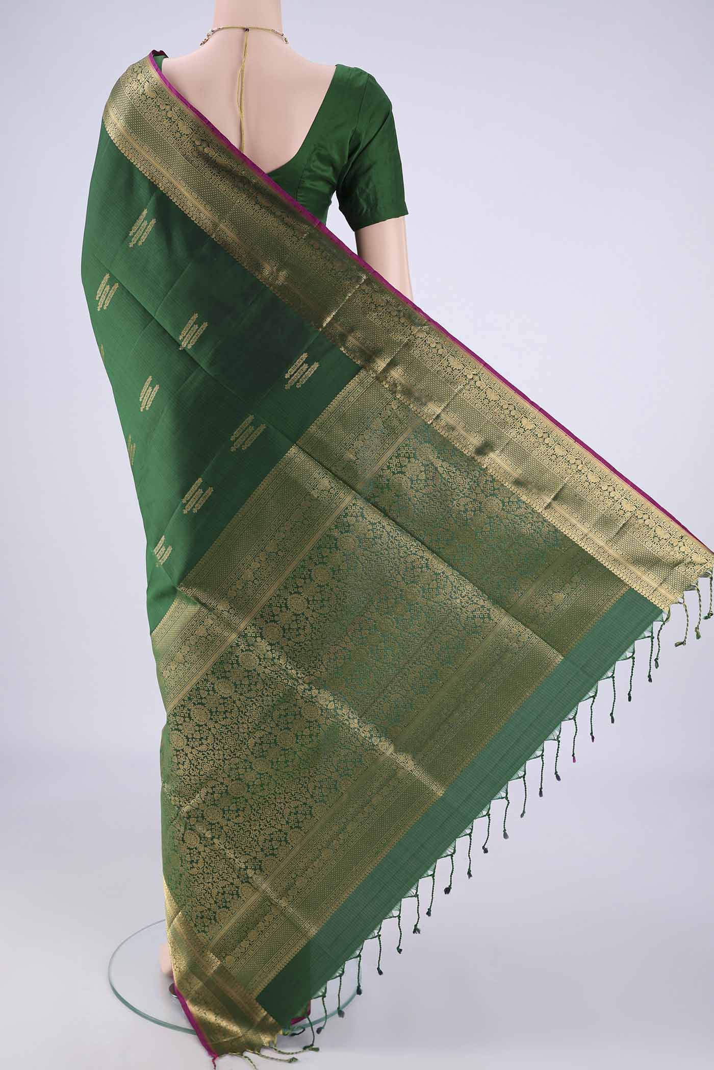 Flat view of Bottle Green Soft Silk Saree with Zari Butta on the body and Zari Border. 