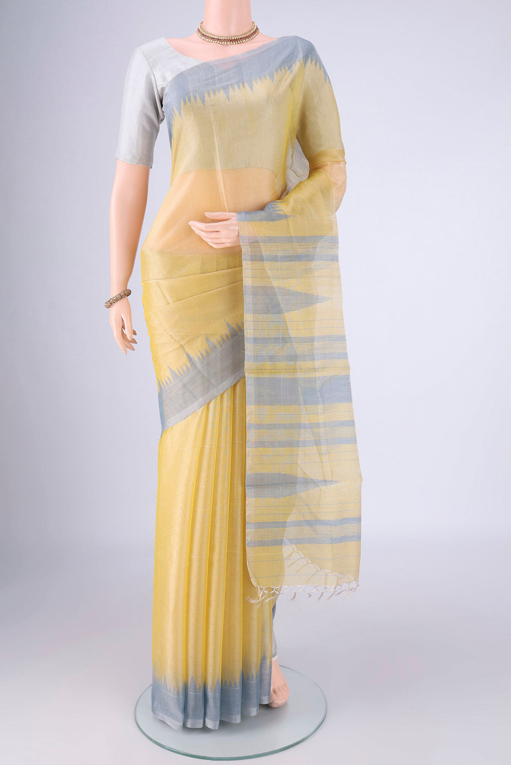 Lemon Yellow MP Tussar Saree with Plain Body and Temple Border.  displayed on a mannequin