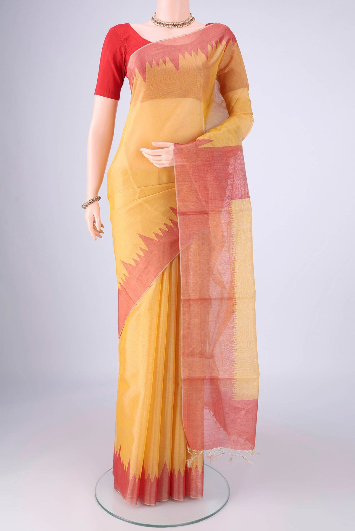 Yellow MP Tussar Saree with Plain Body and Temple Border.  displayed on a mannequin