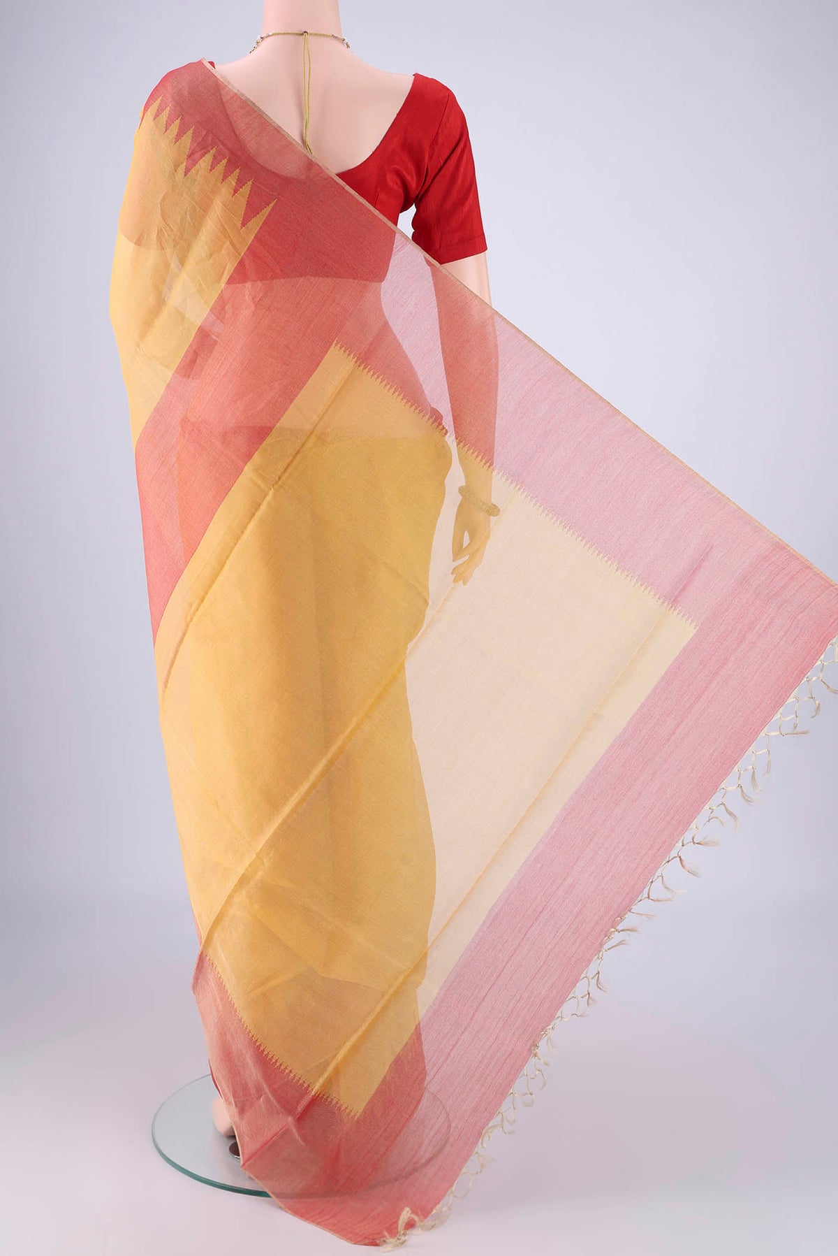 Flat view of Yellow MP Tussar Saree with Plain Body and Temple Border. 
