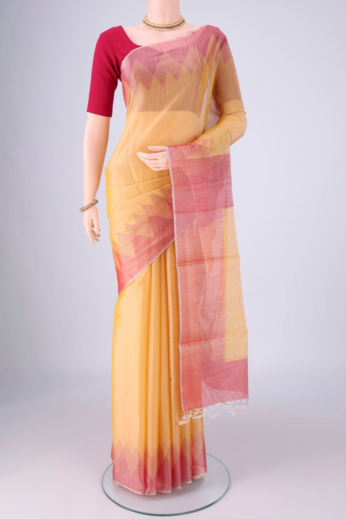 Yellow MP Tussar Saree with Plain Body and Temple Border.  displayed on a mannequin