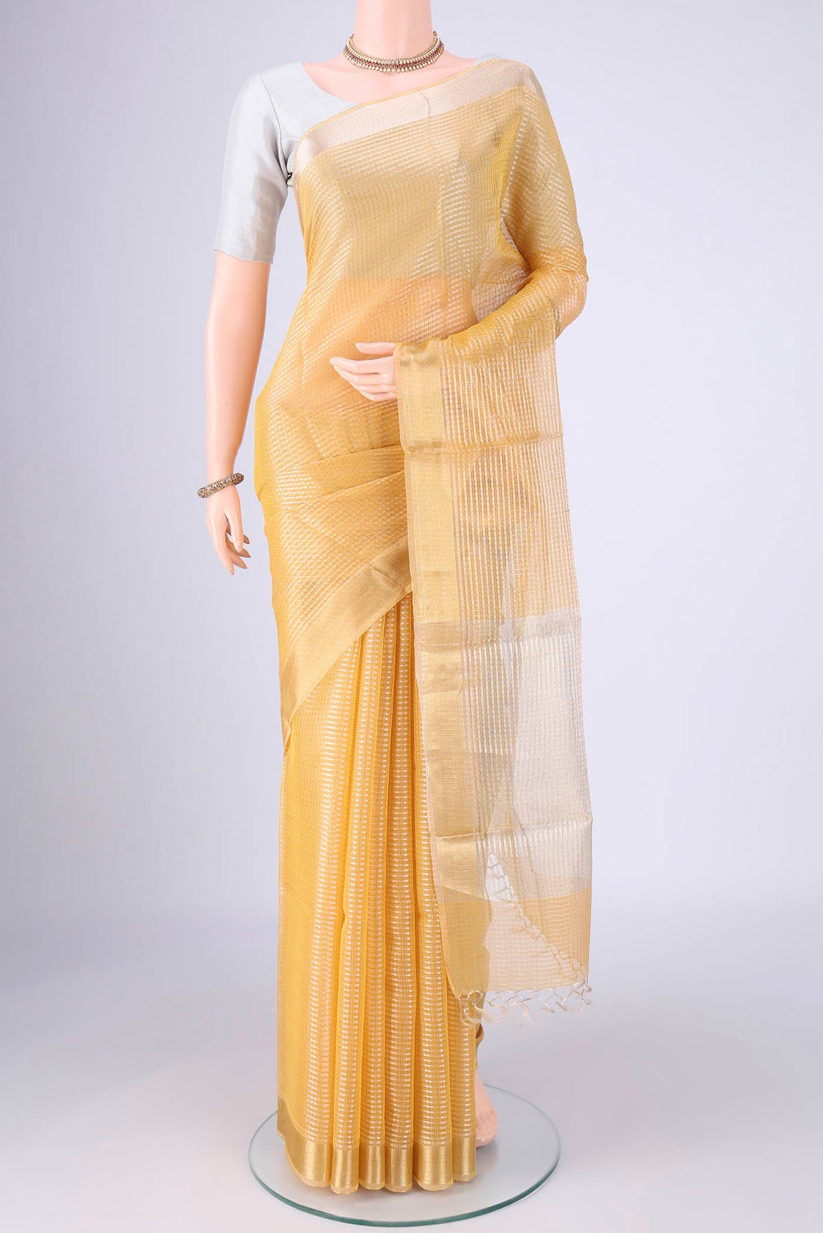 Lemon Yellow MP Tussar Saree with Checked design on the body and Zari Border.  displayed on a mannequin