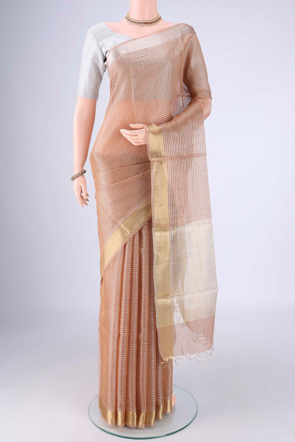 Rose Gold Tussar Silk Saree with Checked design on the body and Zari Border.  displayed on a mannequin