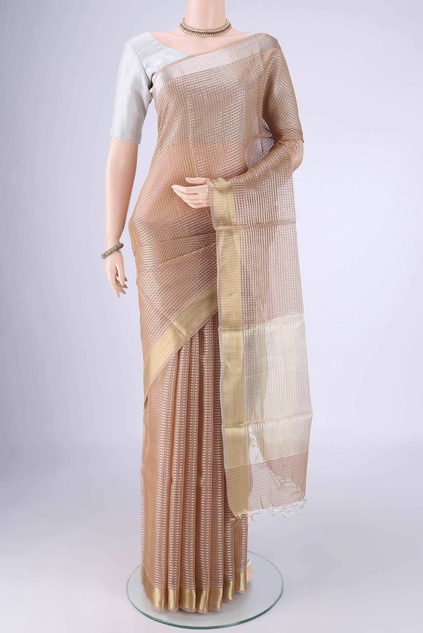 Rose Gold Tussar Silk Saree with Checked design on the body and Zari Border.  displayed on a mannequin