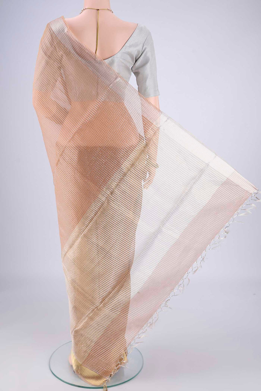 Flat view of Rose Gold Tussar Silk Saree with Checked design on the body and Zari Border. 