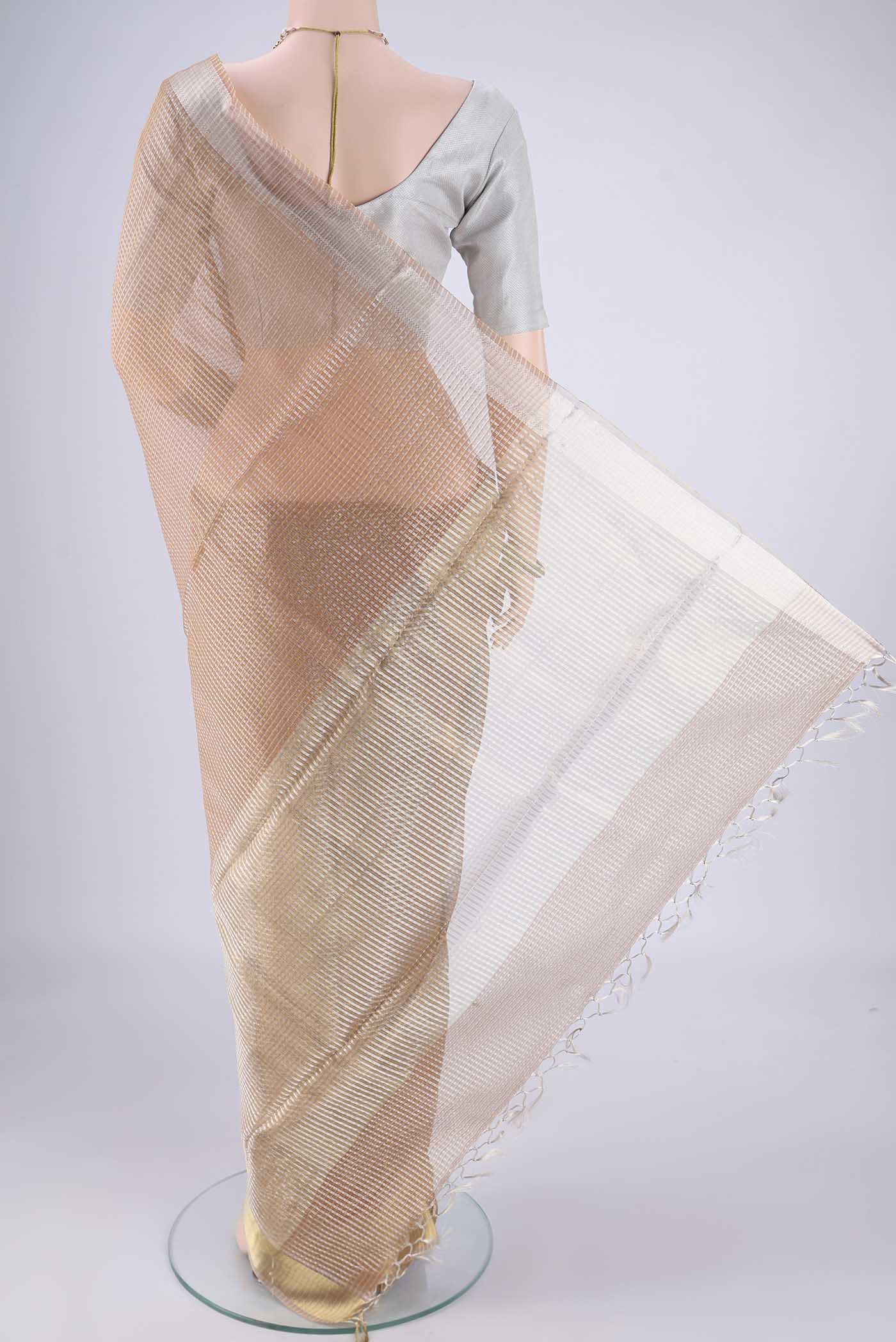 Flat view of Rose Gold Tussar Silk Saree with Checked design on the body and Zari Border. 