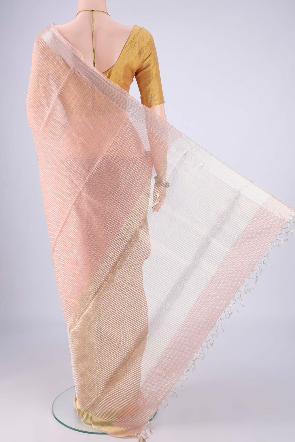 Flat view of Peach Tussar Silk Saree with Checked design on the body and Zari Border. 