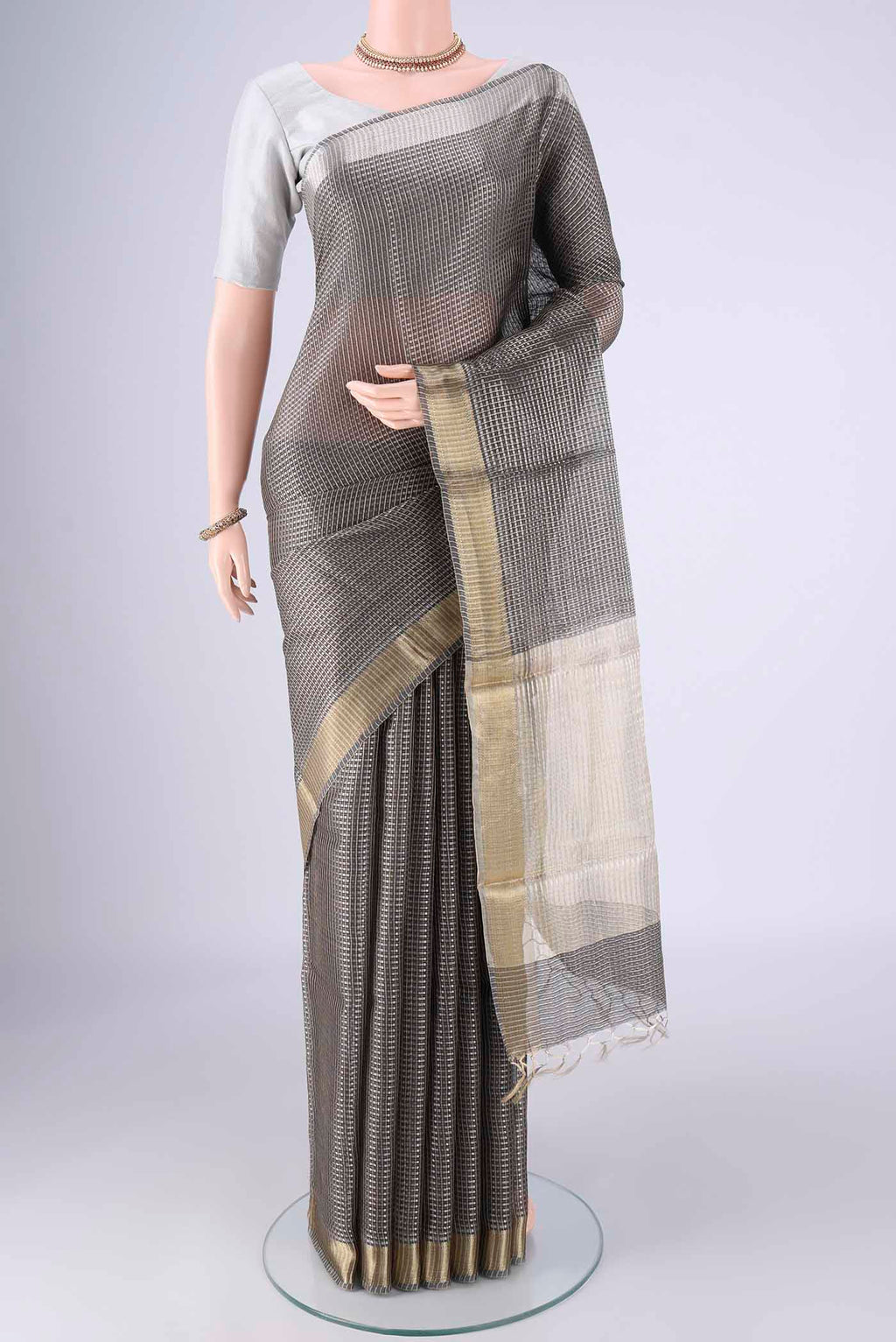 Davys Grey Tussar Silk Saree with Checked design on the body and Zari Border.  displayed on a mannequin