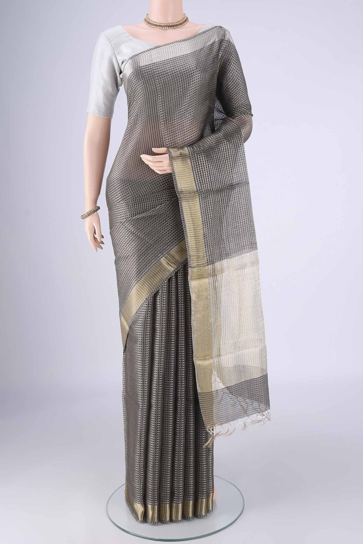 Davys Grey Tussar Silk Saree with Checked design on the body and Zari Border.  displayed on a mannequin