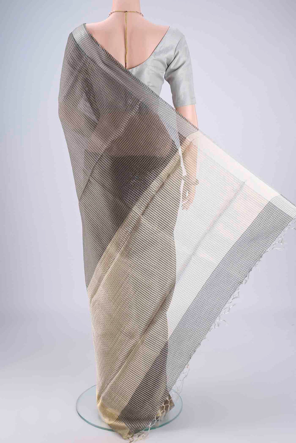 Flat view of Davys Grey Tussar Silk Saree with Checked design on the body and Zari Border. 