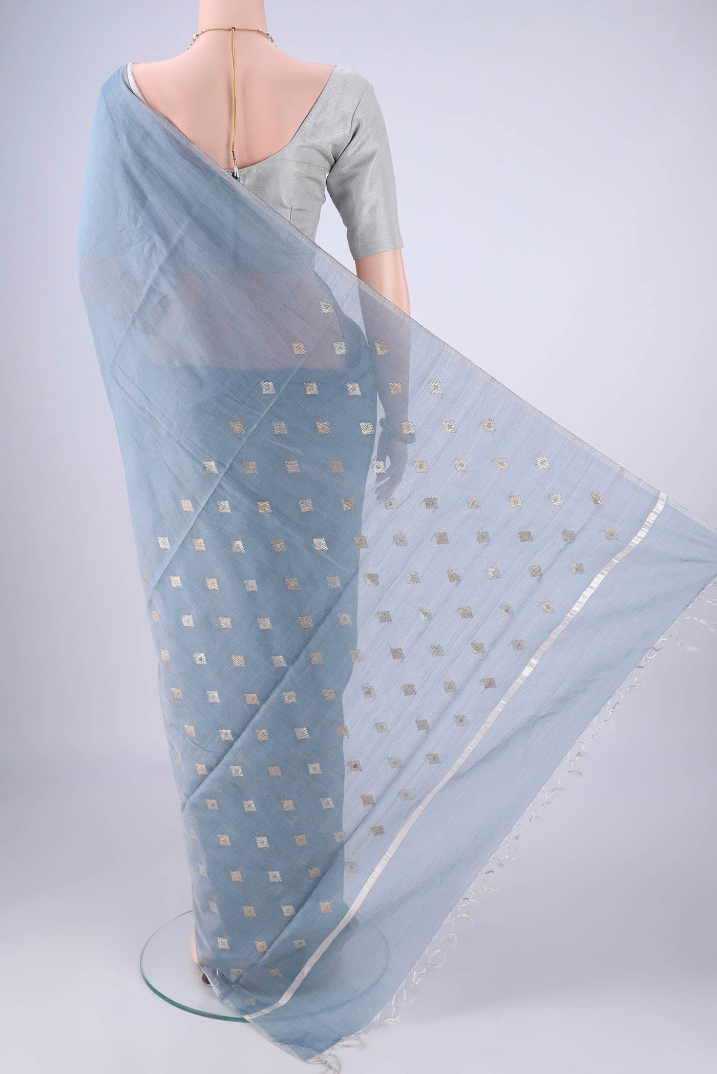 Flat view of Sky Blue MP Tussar Saree with Zari Butta on the body and Thin Zari Line. 