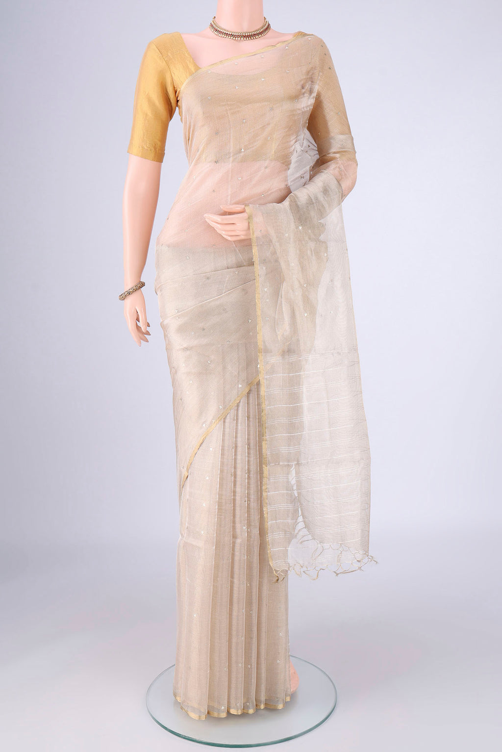 Golden MP Tussar Saree with Embroidery on the body and Zari Border.  displayed on a mannequin