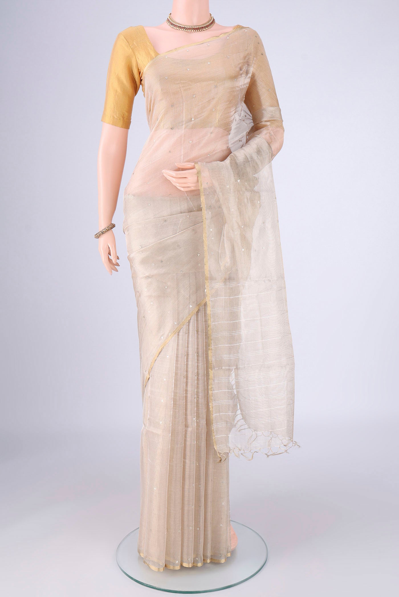 Golden MP Tussar Saree with Embroidery on the body and Zari Border.  displayed on a mannequin