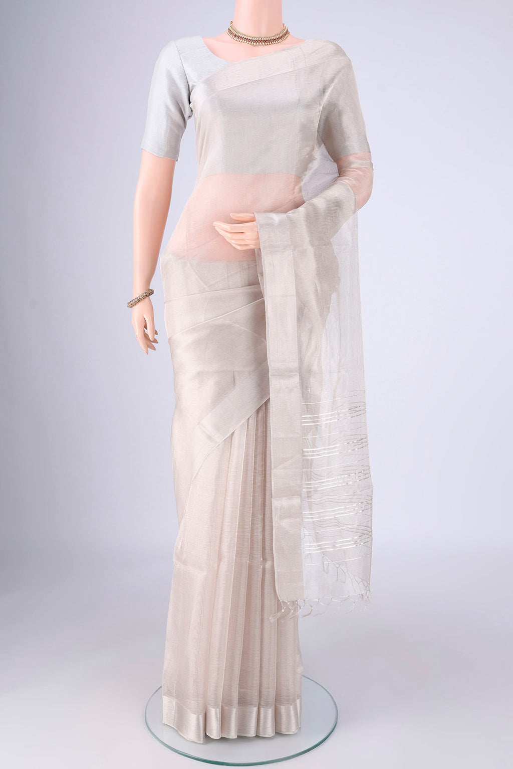 Silver MP Tussar Saree with Plain Body and Zari Border.  displayed on a mannequin