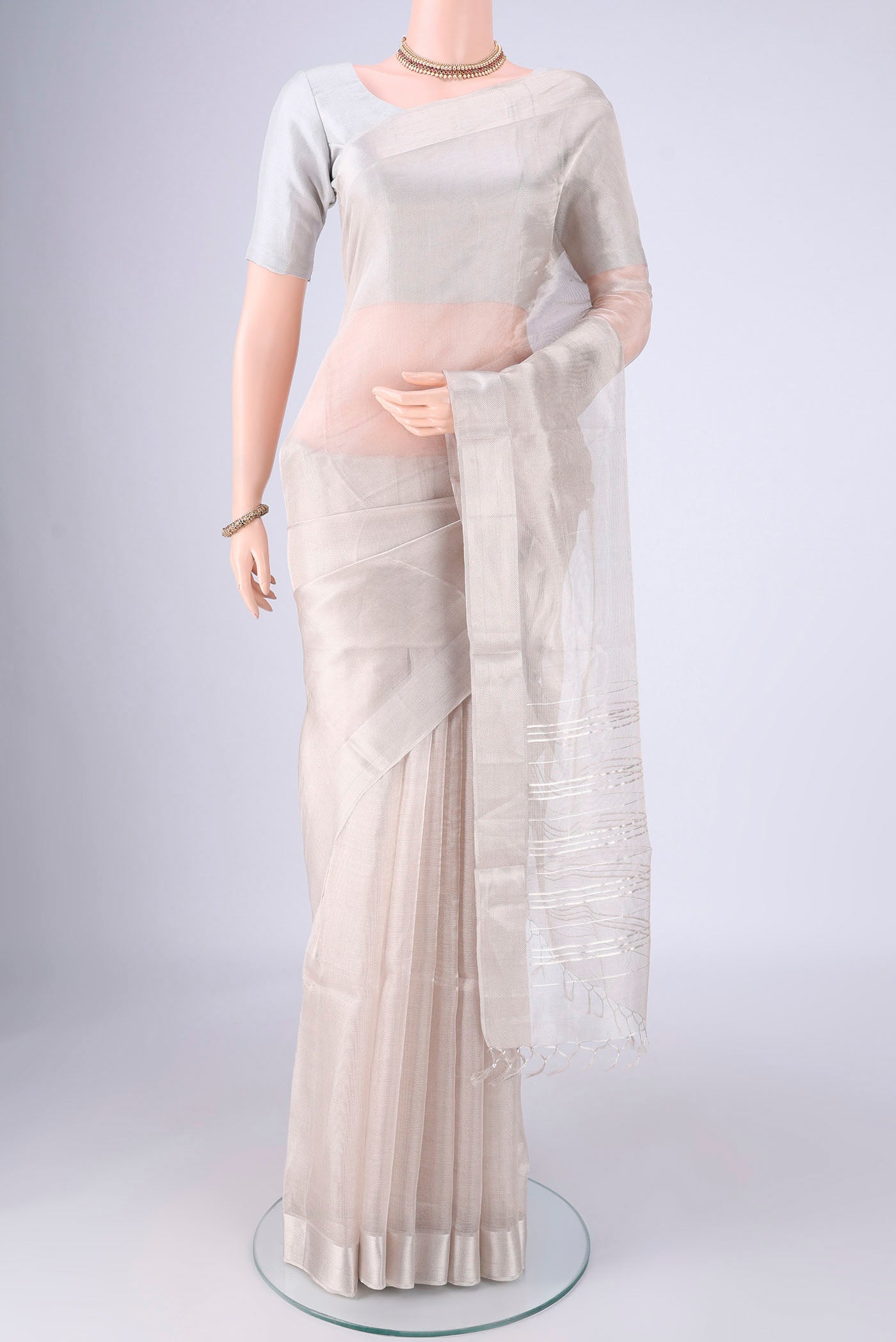 Silver MP Tussar Saree with Plain Body and Zari Border.  displayed on a mannequin
