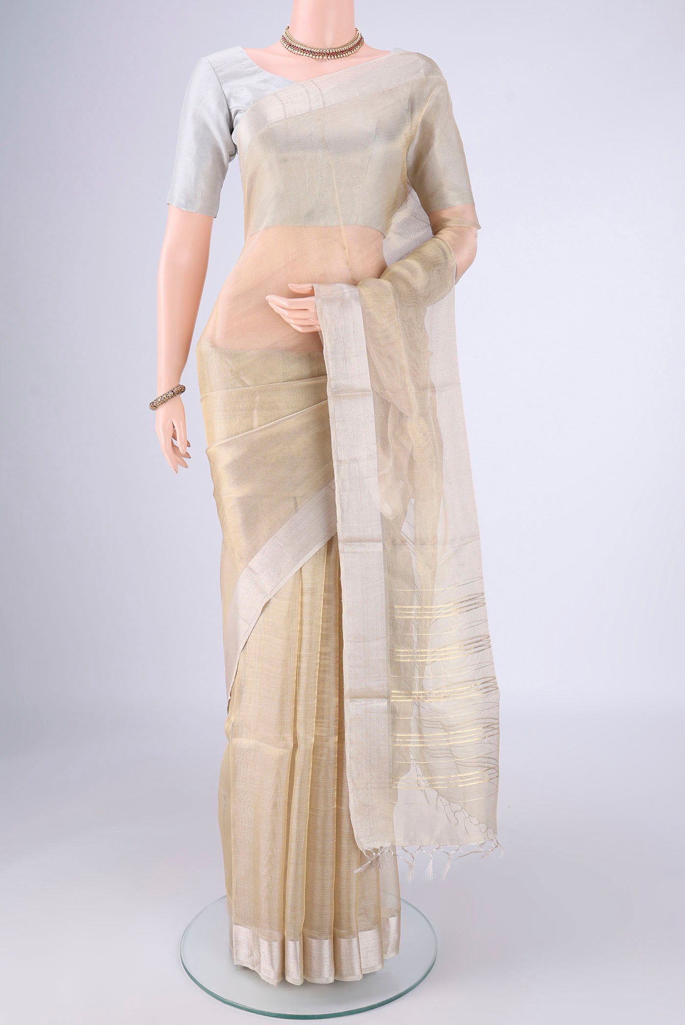 Golden MP Tussar Saree with Plain Body and Zari Border.  displayed on a mannequin