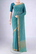 Peacock Blue Mangalagiri Cotton Saree with Printed design on the body and Zari Border.  displayed on a mannequin
