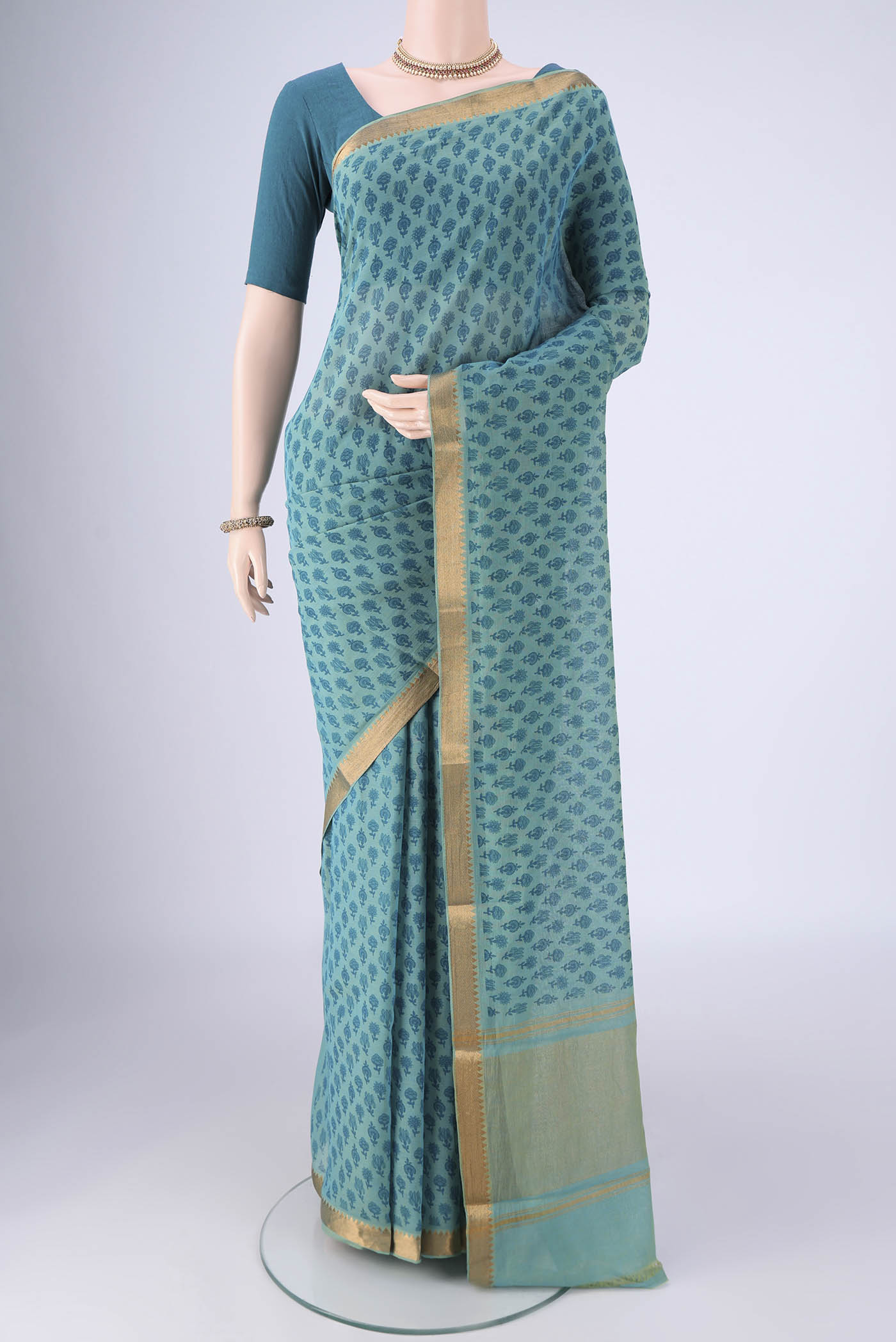 Peacock Blue Mangalagiri Cotton Saree with Printed design on the body and Zari Border.  displayed on a mannequin