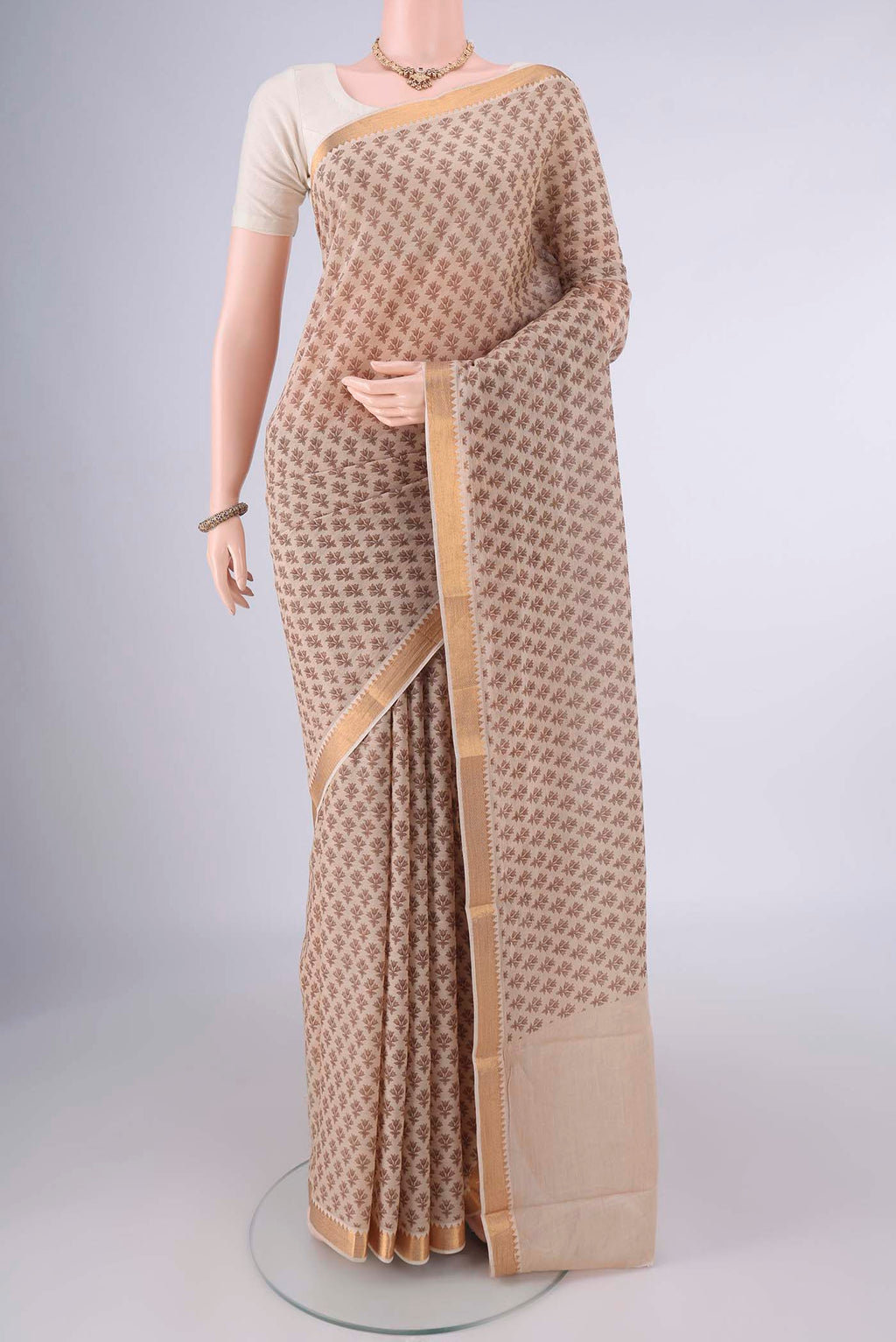 Beige Mangalagiri Cotton Saree with Printed design on the body and Zari Border.  displayed on a mannequin